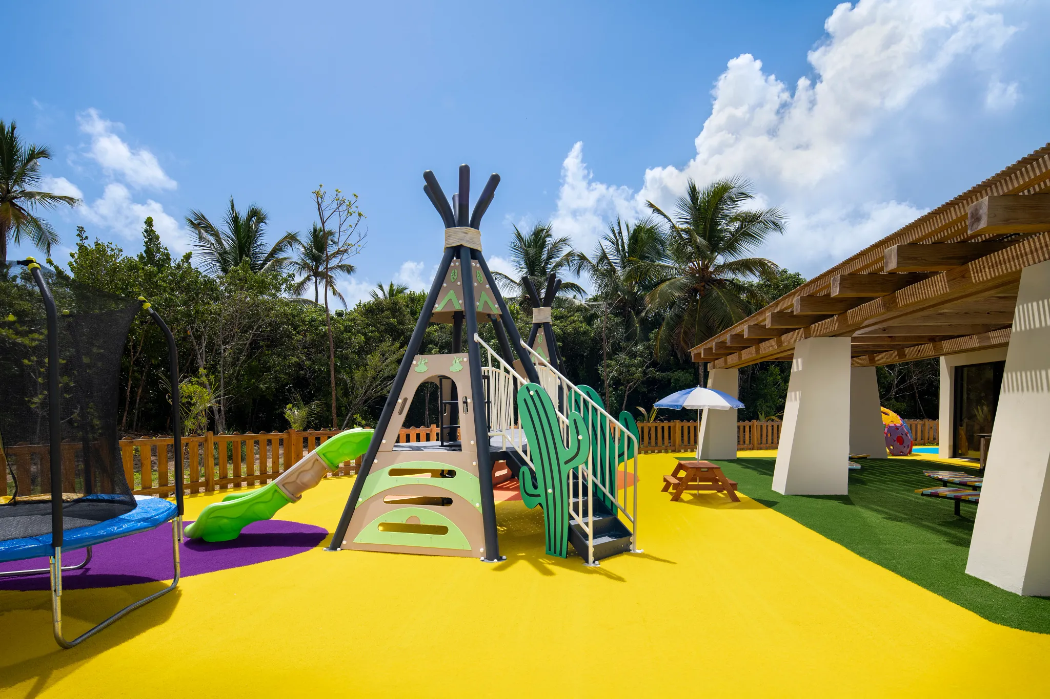 Colorful outdoor playground and trampoline at Dreams Playa Esmeralda Resort & Spa, designed for family-friendly activities and kids’ entertainment.