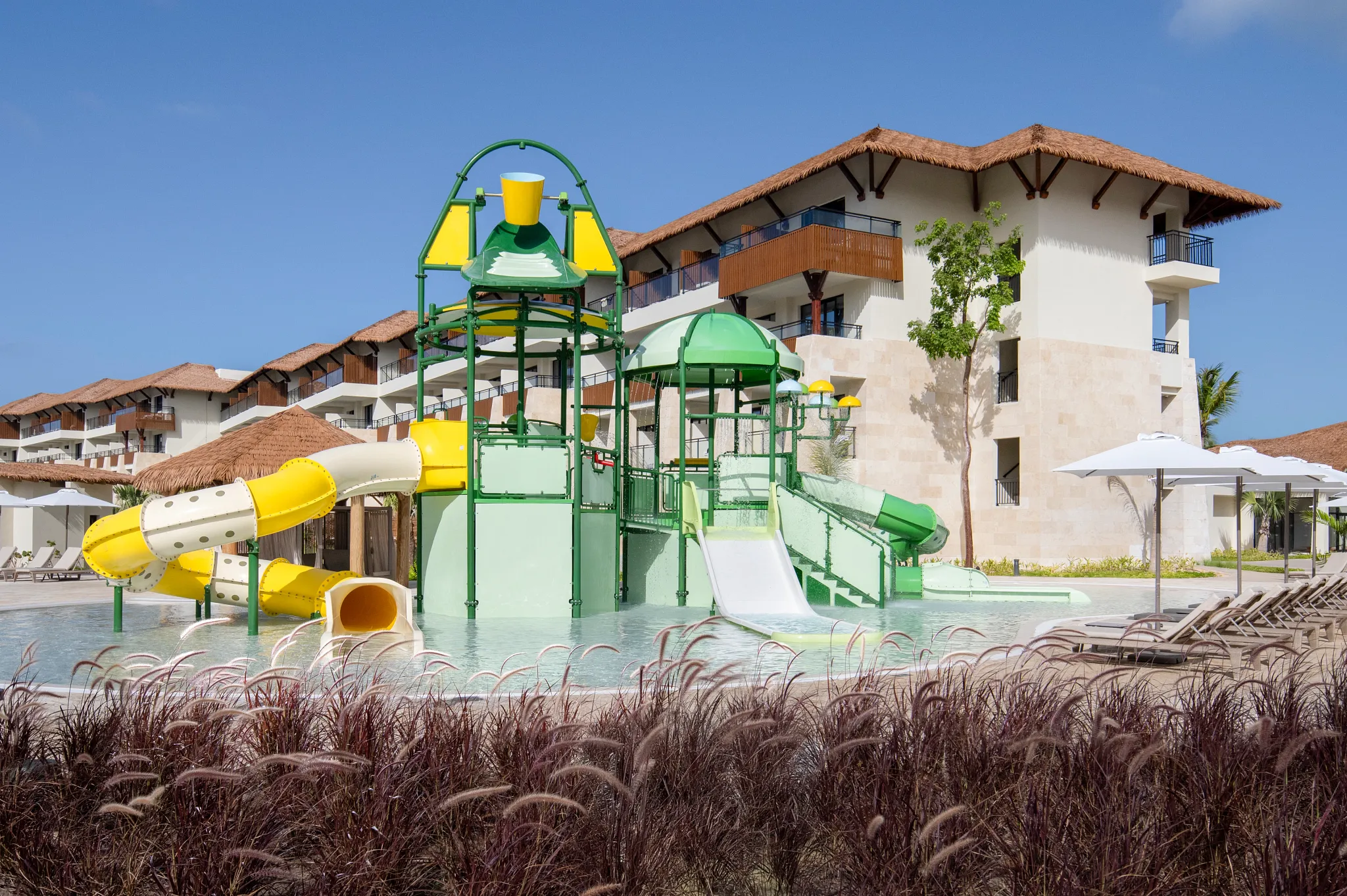 Colorful kids water park with splash features and slides at Dreams Playa Esmeralda Resort & Spa.